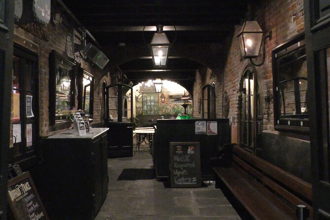 New Orleans Lewd Spirits Haunted Tour with Bar Stops - Walking through the French Quarter after dark